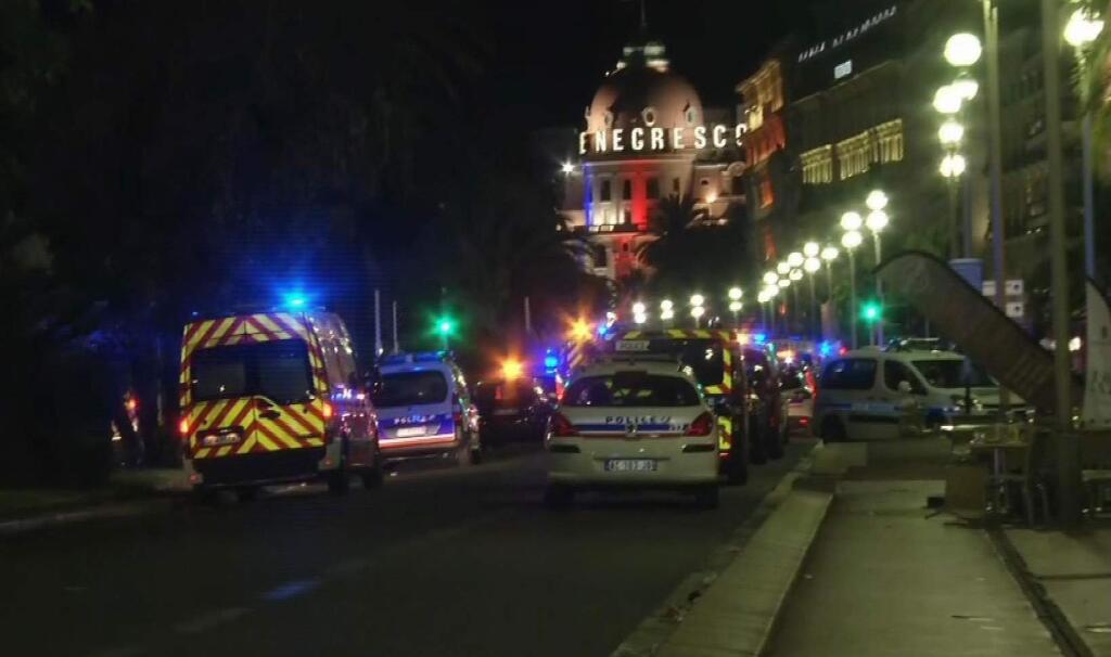 In this video grab taken Thursday July 14, 2016, ambulances and Police cars are seen after a truck drove on to the sidewalk and plowed through a crowd of revelers who'd gathered to watch the fireworks in the French resort city of Nice. officials and eyewitnesses described as a deliberate attack. There appeared to be many casualties. (BFMTV via AP)