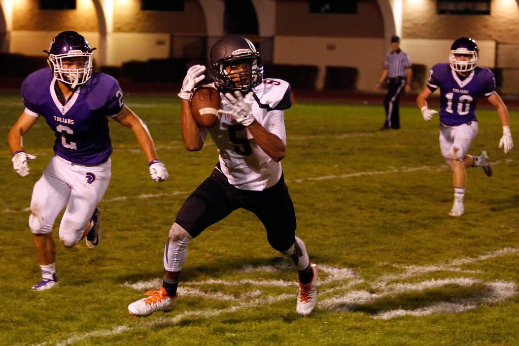 Santa Rosa's Kalei Aukai (5) makes a catch in front of Petaluma's (2) during their game on Sept. 18. Santa Rosa will drop from Division 1 to Division 2 in football this fall because of new procedures adopted Tuesday by the North Coast Section Board of Managers. (Alvin Jornada / The Press Democrat)