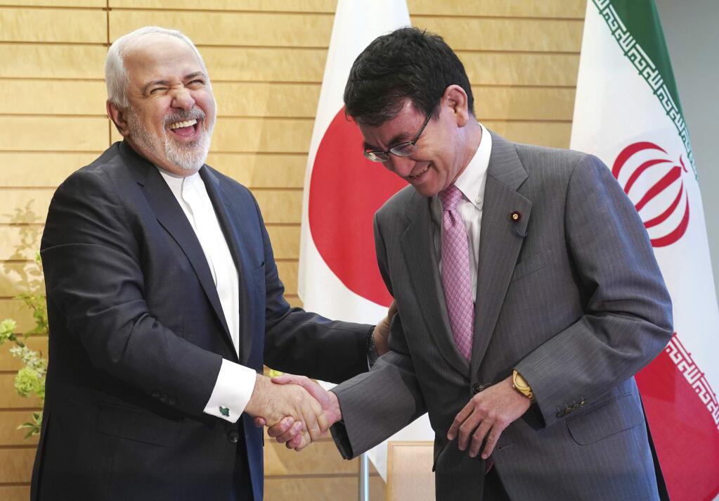 Iranian Foreign Minister Mohammad Javad Zarif, left, and Japanese Foreign Minister Taro Kono, right, shake hands at the Prime Minister's official residence in Tokyo Thursday, May 16, 2019. Iran's foreign minister has said his country is committed to an international nuclear deal and criticized escalating U.S. sanctions “unacceptable” as he met with Japanese officials in Tokyo amid rising tensions in the Middle East. (AP Photo/Eugene Hoshiko, Pool)