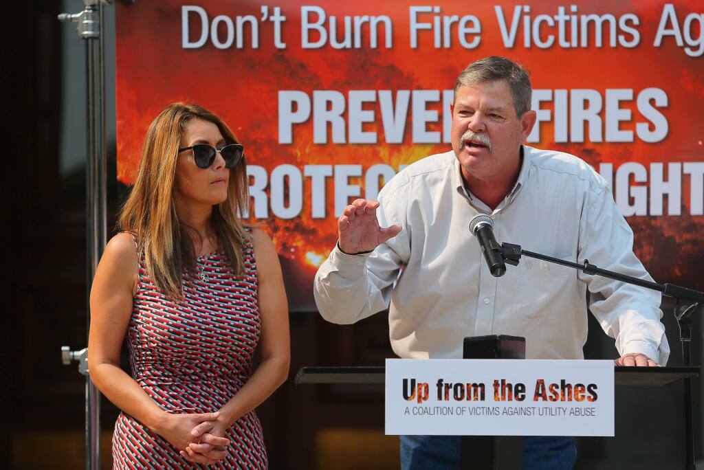 Thomas fire victim Richard Atmore, with his wife, Bonnie, of Ventura, speaks to a group attending the 'Fire Victims Day at the Capitol' event, held by Up from the Ashes, in Sacramento on Wednesday, Aug. 8, 2018. (CHRISTOPHER CHUNG/ PD)