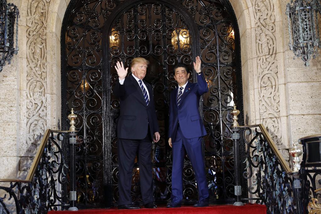 President Donald Trump and Japanese Prime Minister Shinzo Abe wave at Trump's private Mar-a-Lago club, Tuesday, April 17, 2018, in Palm Beach, Fla. (AP Photo/Pablo Martinez Monsivais)
