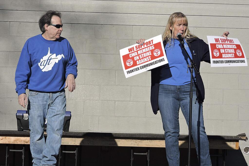 Frank Caputo, AFT?staff representative and AFT?vice president Stacey Strawderman speak in support of the Communications Workers of America strike which began Sunday at a teachers rally in Palatine Park in Fairmont, W.Va., Sunday, March 4, 2018. (Eddie Trizzino/Times-West Virginian via AP)