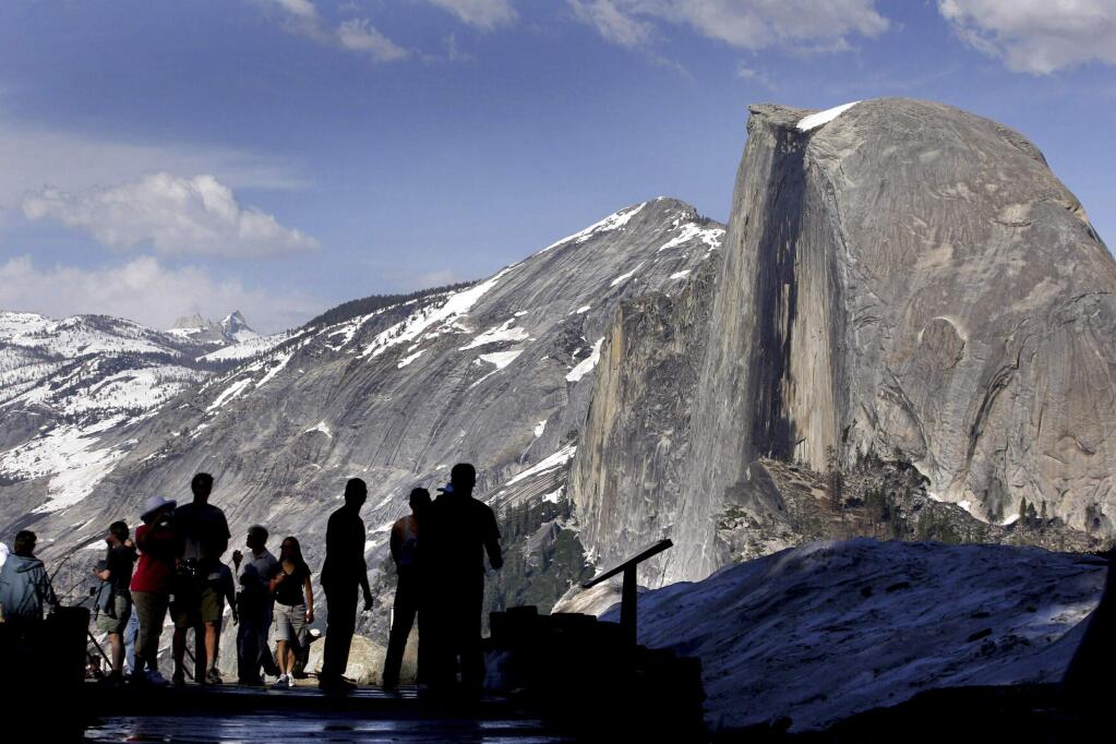 In this 2005 file photo, visitors view Half Dome from Glacier Point at Yosemite National Park, Calif. (AP Photo/Dino Vournas, File)