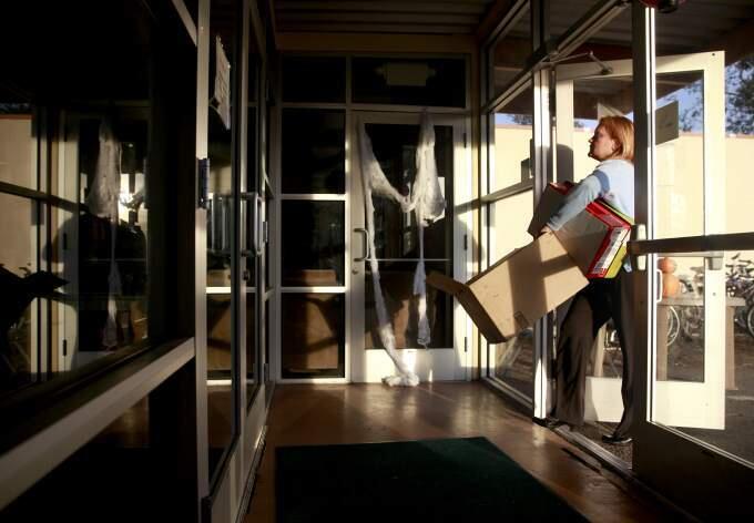 Heidi Besonis carries in boxes in order to pack her things and move out of Sam Jones Hall in Santa Rosa, California on Monday, November 3, 2014. (BETH SCHLANKER/ The Press Democrat)