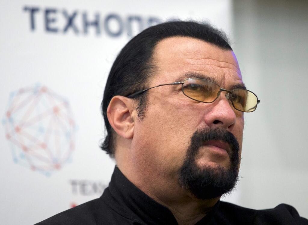 FILE - In this Sept. 22, 2015, file photo, actor Steven Seagal speaks at a news conference, while attending an opening ceremony for a research and development center in Moscow, Russia. An aspiring actress says she was 17 when actor Steven Seagal sexually assaulted her during a supposed casting session in 2002. (AP Photo/Ivan Sekretarev, File)