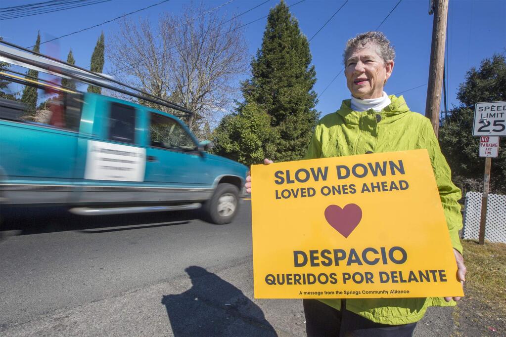 Cathy Wade Shepard says speeding cars have increased since Boyes Boulevard was repaved, and she's helping distribute signs to ask drivers to slow down. (Photo by Robbi Pengelly/Index-Tribune)