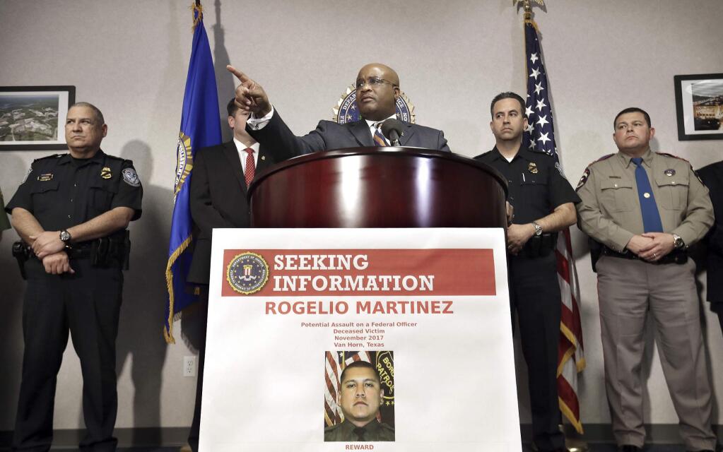 FBI Special Agent in Charge of the El Paso field office Emmerson Buie Jr. speaks during a press conference at the FBI field office, Tuesday, Nov. 21, 2017, in El Paso, Texas, about the death of a border patrol agent and the severe injuries of a second agent. FBI officials said Tuesday that officers are investigating the incident as a “potential physical assault” on federal officers, but said there are several scenarios that might have led to the agents' injuries. (Mark Lambie/The El Paso Times via AP)