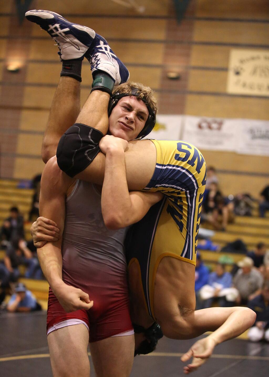 Healdsburg's Jacob Sloma, left, defeated Napa's Alec Richmond in the 170 weight class during the King of the Mat wrestling tournament held at Windsor High School, Saturday, January 17, 2015. (Crista Jeremiason / The Press Democrat)