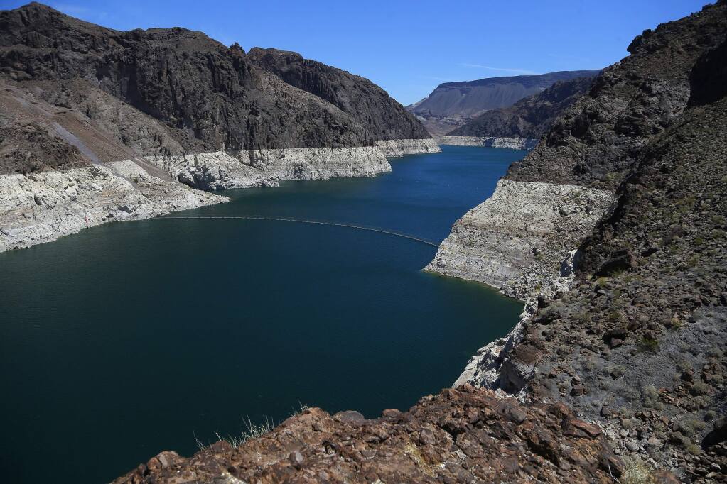 The low level of the water line is shown on the banks of the Colorado River, Thursday, May 31, 2018, in Hoover Dam, Ariz. Arizona is renewing a focus on a drought contingency plan for the shrinking supply of Colorado River water, and other Western states are paying close attention. (AP Photo/Ross D. Franklin)