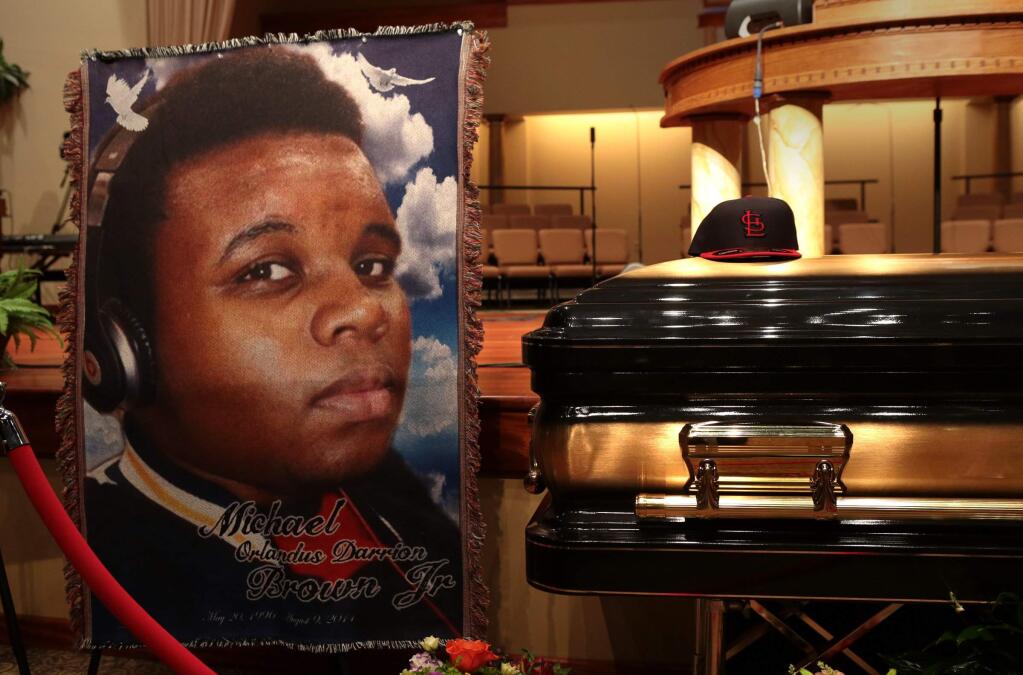 The casket of Michael Brown sits inside Friendly Temple Missionary Baptist Church awaiting the start of his funeral on Monday, Aug. 25, 2014. Brown, who is black, was unarmed when he was shot Aug. 9 in Ferguson, Mo., by Officer Darren Wilson, who is white. Protesters took to the streets of the St. Louis suburb night after night, calling for change and drawing national attention to issues surrounding race and policing. (AP Photo/St. Louis Post Dispatch, Robert Cohen, Pool)