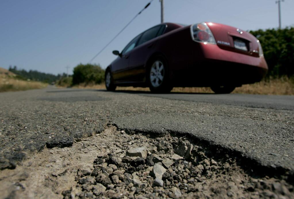 A pothole on a Sonoma Road. File photo. (Kent Porter / The Press Democrat)