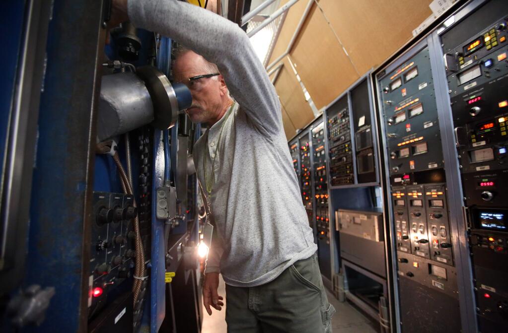 Manufacturing supervisor Michael Biagini monitors sources in the Multilayer Automatic Coater, at MAC Thin Films, Inc., in Santa Rosa on Tuesday, December 2, 2014. (Christopher Chung/ The Press Democrat)