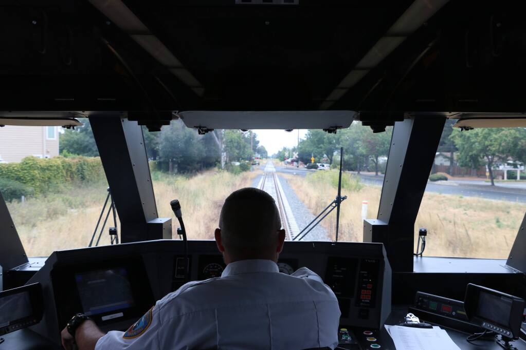 Scott Mitchell, one of 11 train engineers for Sonoma-Marin Area Rail Transit system, takes the public on a test ride in August 2016. (ANGELA HART/ PD FILE)