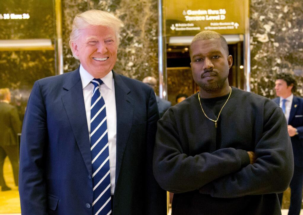 FILE - In this Dec. 13, 2016, file photo, then-President-elect Donald Trump and Kanye West pose for a picture in the lobby of Trump Tower in New York. Trump is tweeting his thanks to rap superstar Kanye West for his recent online support. Trump wrote, “Thank you Kanye, very cool!” in response to the tweets from West, who called the president “my brother.” West tweeted a number of times Wednesday expressing his admiration for Trump, saying they both share “dragon energy.” The rap star also posted a photo of himself wearing Trump's campaign “Make America Great Again” hat. (AP Photo/Seth Wenig, File)