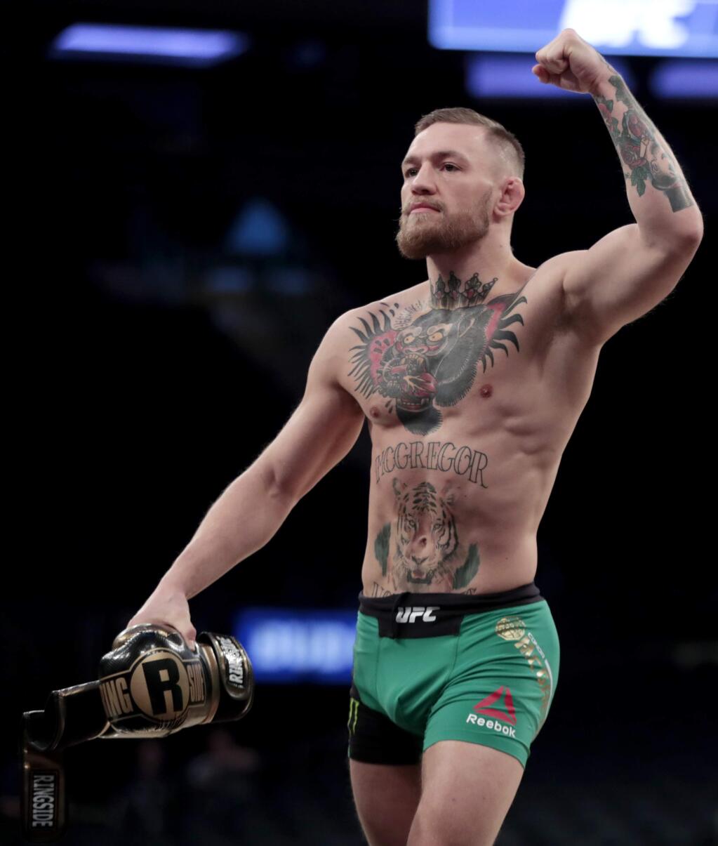 Conor McGregor gestures toward fans while working out ahead of his UFC 205 mixed martial arts bout against Eddie Alvarez Wednesday, Nov. 9, 2016, at Madison Square Garden in New York. (AP Photo/Julio Cortez)