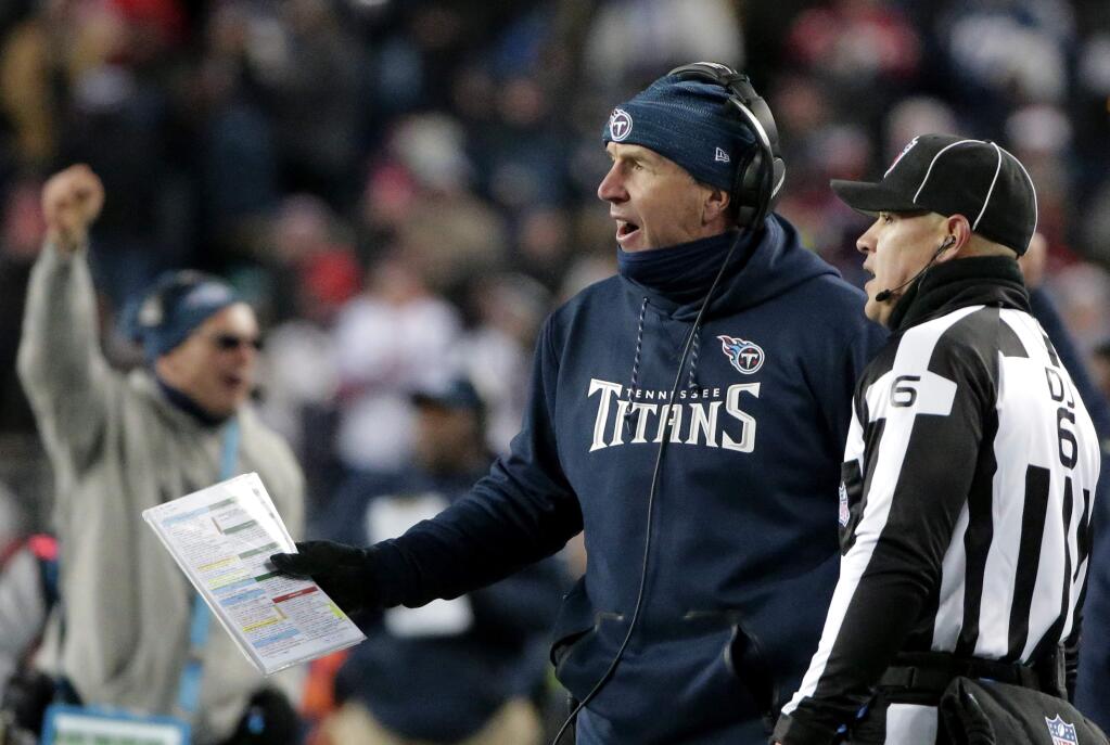 Tennessee Titans head coach Mike Mularkey speaks to down judge Jerod Phillips on the sideline during the first half of an NFL divisional playoff football game against the New England Patriots, Saturday, Jan. 13, 2018, in Foxborough, Mass. (AP Photo/Steven Senne)