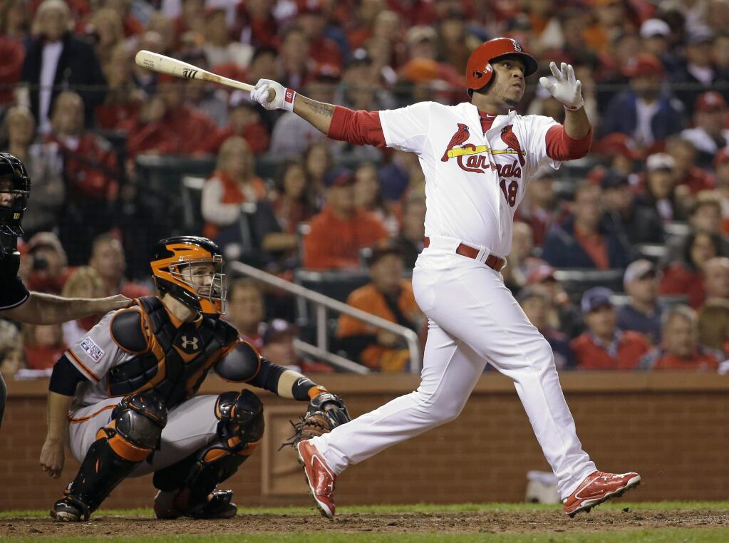 FILE - This Oct. 12, 2014 file photo shows St. Louis Cardinals' Oscar Taveras hitting a home run during the seventh inning of Game 2 of the National League baseball championship series against the San Francisco Giants in St. Louis. Authorities say, Sunday, Oct. 26, 2014, Taveras has died in a car accident in the Dominican Republic. (AP Photo/David J. Phillip, file)
