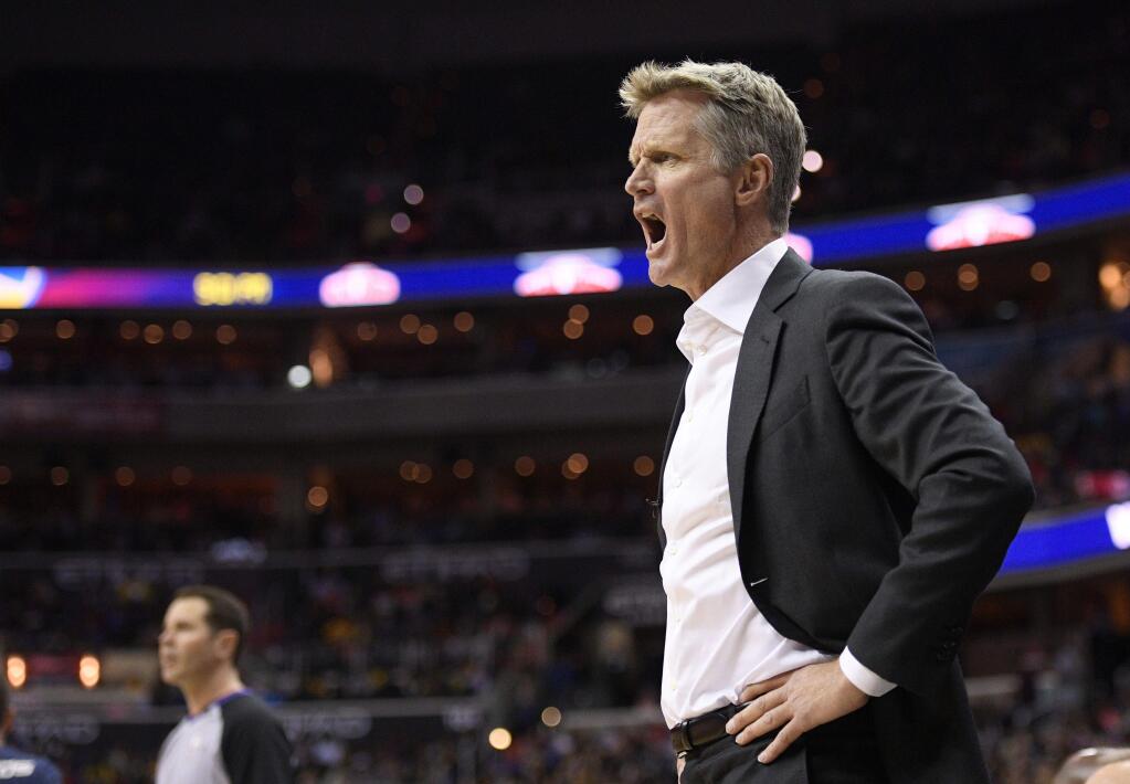 Golden State Warriors coach Steve Kerr yells during the first half of the teame's NBA basketball game against the Washington Wizards, Wednesday, Feb. 28, 2018, in Washington. (AP Photo/Nick Wass)