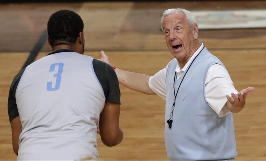 North Carolina head coach Roy Williams, right, talks with forward Kennedy Meeks during a practice session for their NCAA Final Four game Friday, March 31, 2017, in Glendale, Ariz. (AP Photo/Matt York)