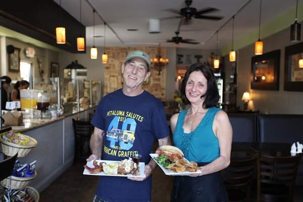 Owners Joe Shea (holding Cinnamon Walnut French Toast with two eggs and applewood smoked bacon) and Lori Shea (Harris Ranch serloin house made Meatball Sandwich) at Food Bar. Photo by Victoria Webb