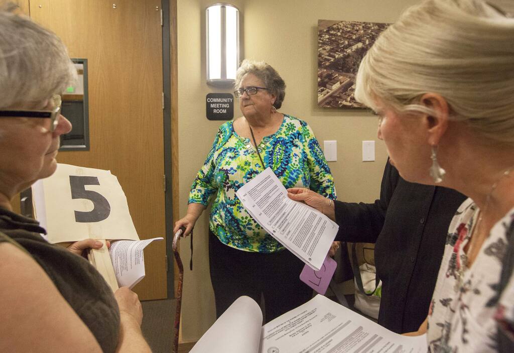 Kathy King (center), executive director of Sonoma Overnight Support, waits outside the community meeting room for their agenda item on a safe parking program in Sonoma be addressed last September. After a three-month trial, King elected not to appy for an extension. (Photos by Robbi Pengelly/Index-Tribune)