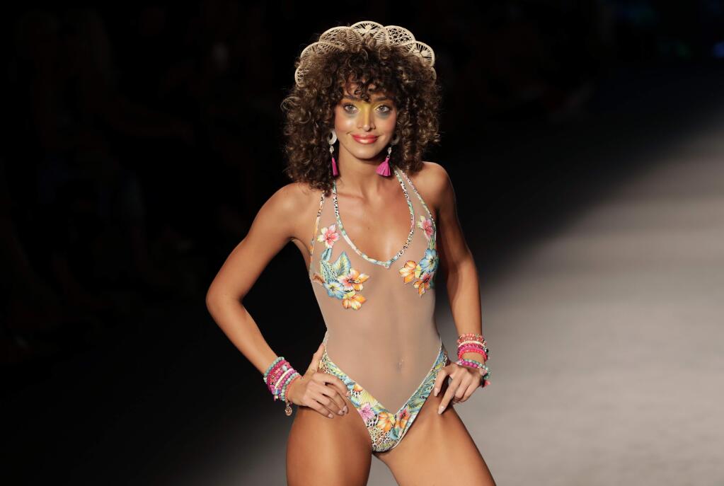 A model walks the runway at the Luli Fama swimwear show during Miami Swim Week, Saturday, July 13, 2019, in Miami Beach, Fla. (AP Photo/Lynne Sladky)