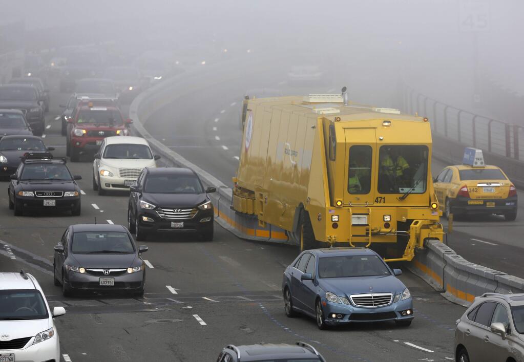 A zipper truck moves the traffic barrier to the center after the morning commute on the Golden Gate Bridge on Monday, Jan.12, 2015 in San Francisco, California. (BETH SCHLANKER/ PD)