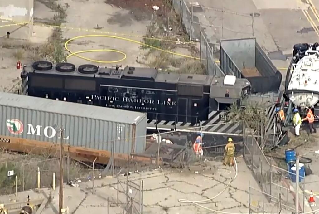 This aerial image taken from video provided by KABC-TV shows a Pacific Harbor Line train that derailed Tuesday, March 31, 2020, at the Port of Los Angeles after running through the end of the track and crashing through barriers, finally coming to rest about 250 yards from the docked U.S. Navy Hospital Ship Mercy. The train engineer intentionally drove the speeding locomotive off a track at the Port of Los Angeles because he was suspicious about the presence of a Navy hospital ship docked there amid the coronavirus crisis. (KABC-TV via AP)