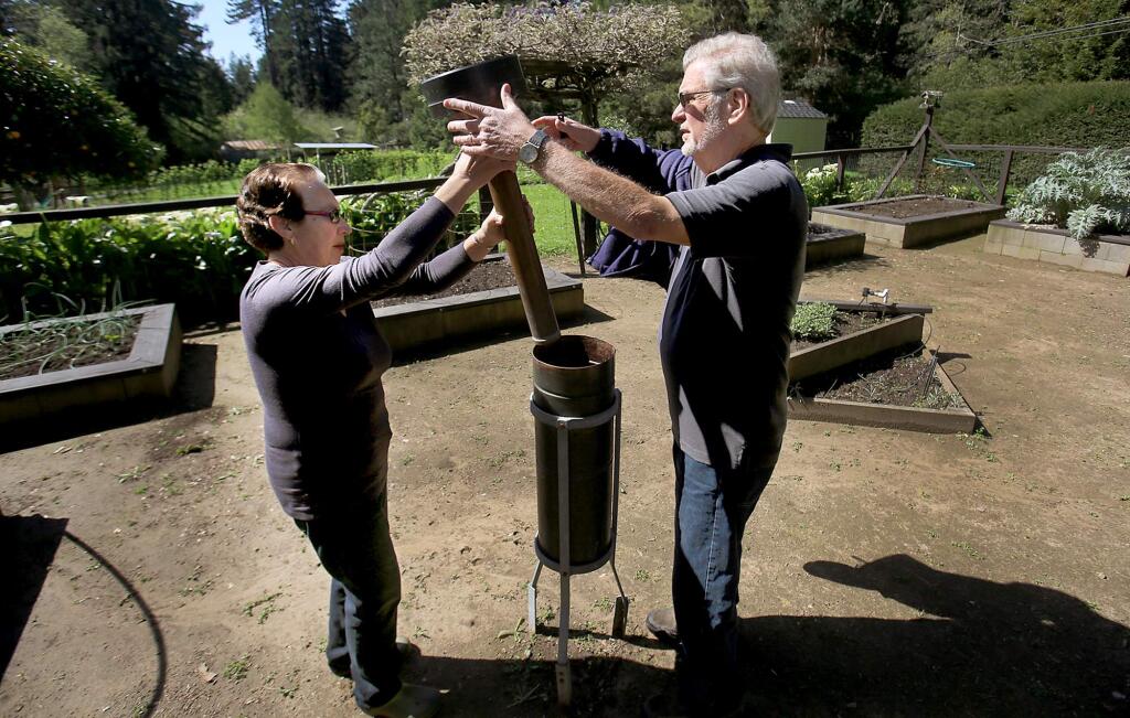 Luci and Ken Farr check their rain gauge at their home in Occidental, Thursday March 23, 2017 and are the last remaining individual cooperative observers for the NWS in Sonoma County, beside automated stations throughout the county. (Kent Porter / The Press Democrat) 2017