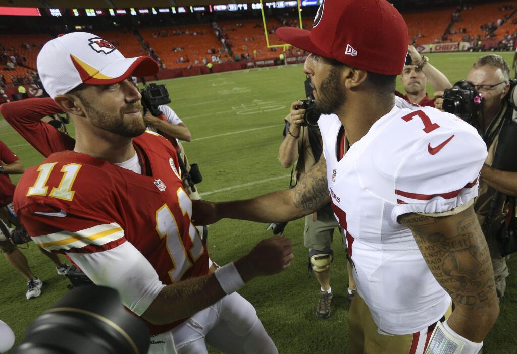 Chiefs quarterback Alex Smith, left, greets 49ers QB Colin Kaepernick after a 2013 preseason game. (AP Photo / Ed Zurga)