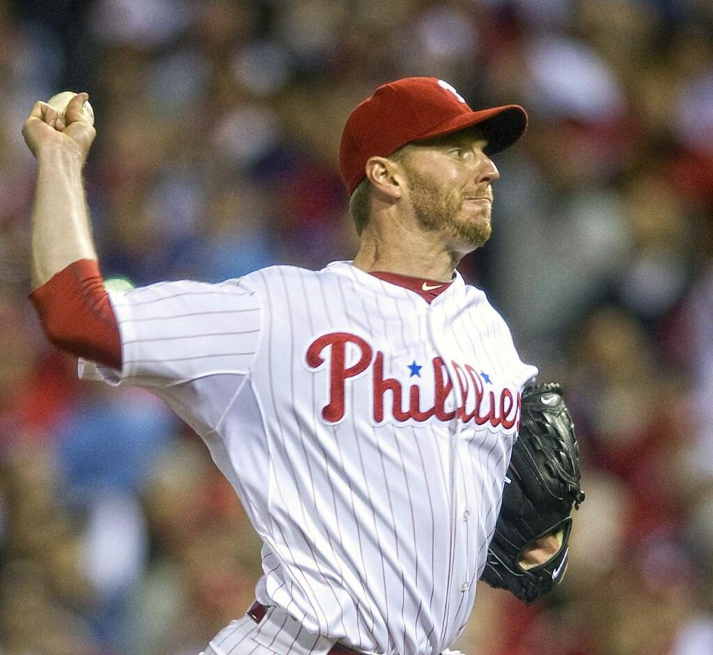 In this Oct. 6, 2010 file photo, Philadelphia Phillies pitcher Roy Halladay, throws against the Cincinnati Reds during Game 1 of the National League Division Series, in Philadelphia. Roy Halladay, a two-time Cy Young Award winner who pitched a perfect game and a playoff no-hitter, died Tuesday when his private plane crashed into the Gulf of Mexico, Tuesday, Nov. 7, 2017. He was 40. (Jose F. Moreno/Camden Courier-Post via AP, File)