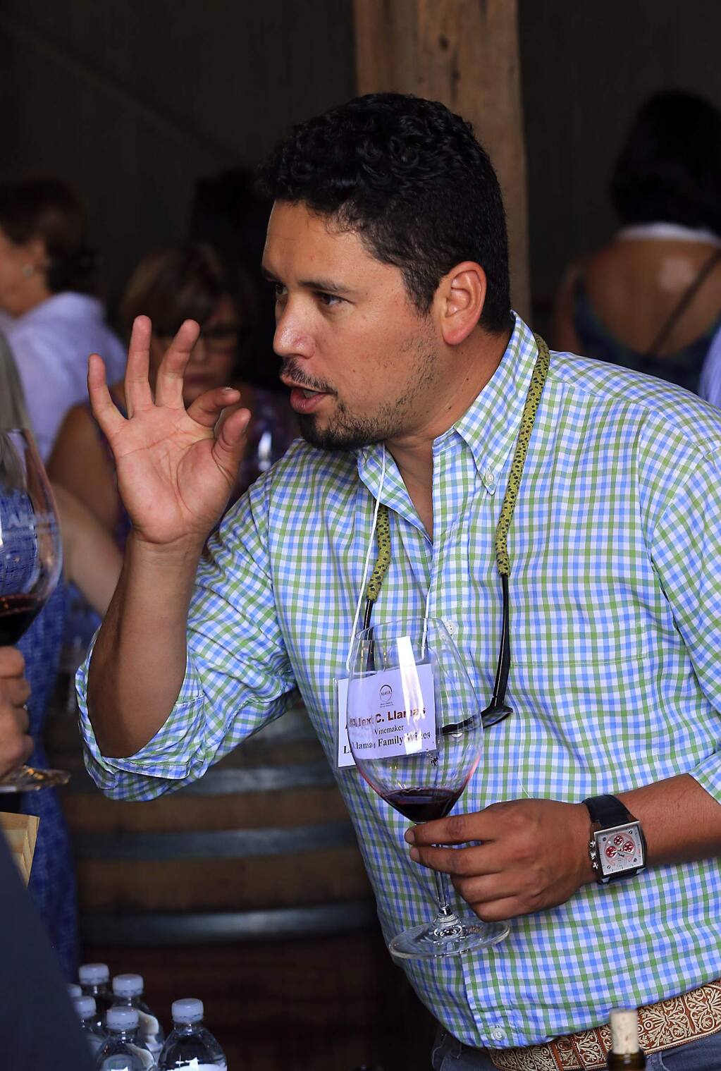Winemaker Alex Llamas pours his Llamas Family Wines at the Mexican-American Vintners Association 6th Annual Harvest Festival at Robledo Family Winery in Sonoma. (JOHN BURGESS/The Press Democrat)