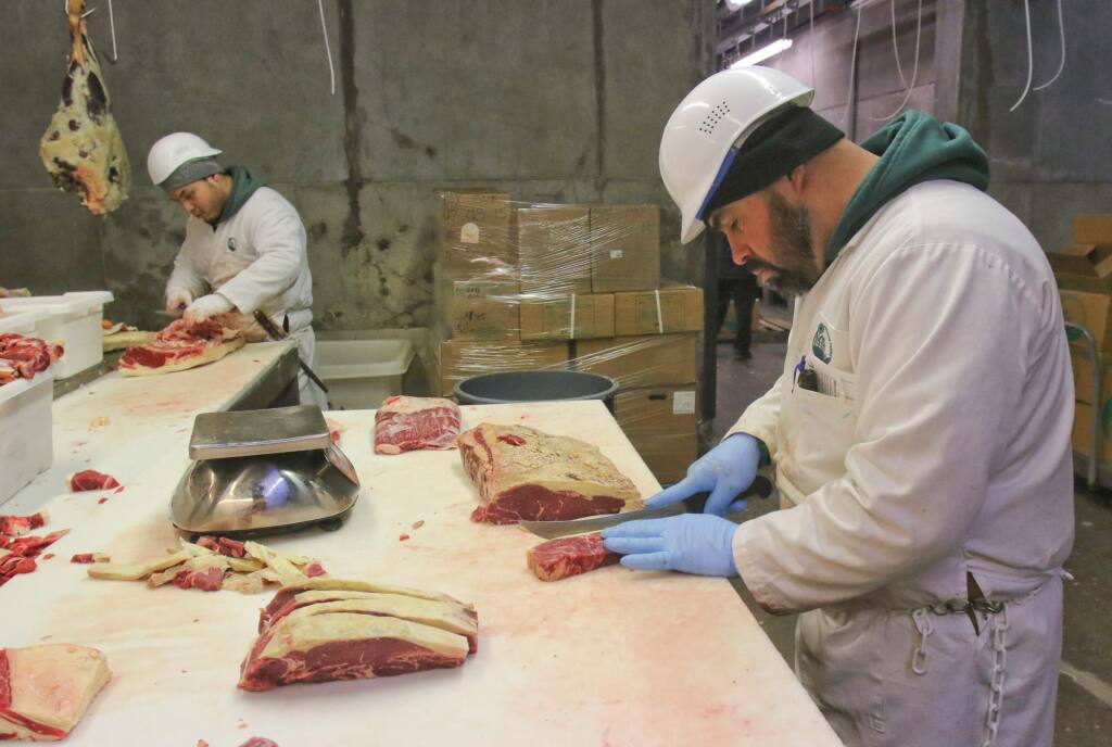 Lead butcher Rafa Lopez cuts New York steaks at Marin Sun Farms in Petaluma on Monday, June 8, 2015.(SCOTT MANCHESTER/ARGUS-COURIER STAFF)