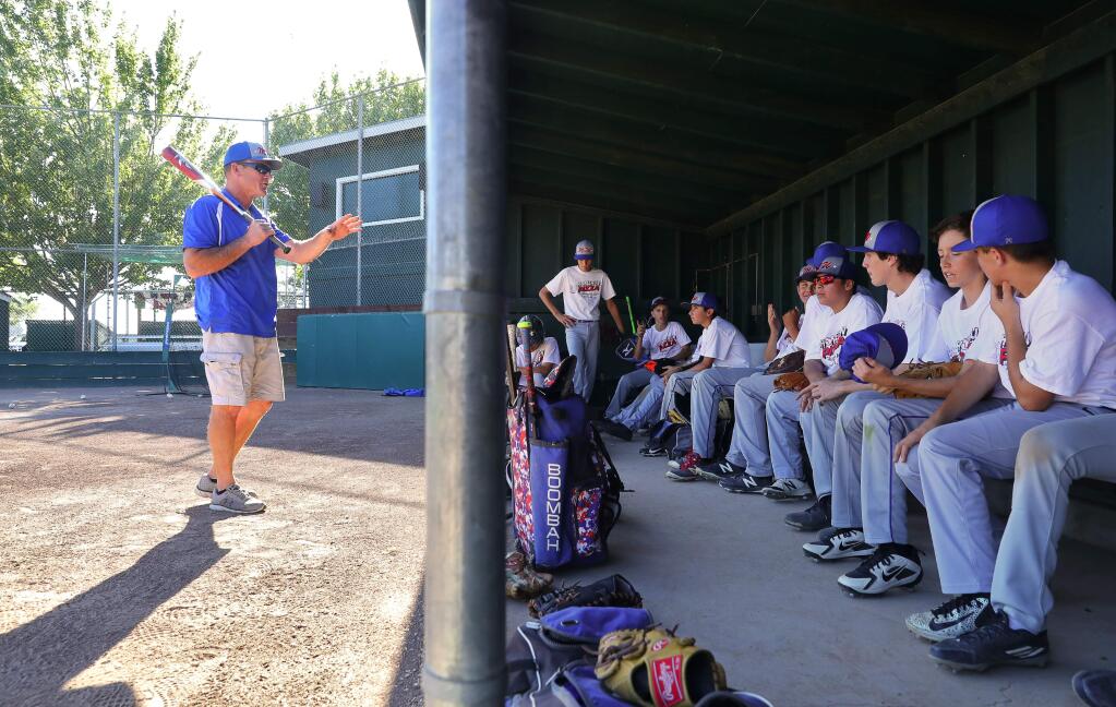 Coach Eric Cannedy talks to his team about an upcoming tournament, during Mark West Little League Intermediate All-Star team practice, in Santa Rosa on Thursday, June 28, 2018. in Santa Rosa on Thursday, June 28, 2018. (Christopher Chung/ The Press Democrat)