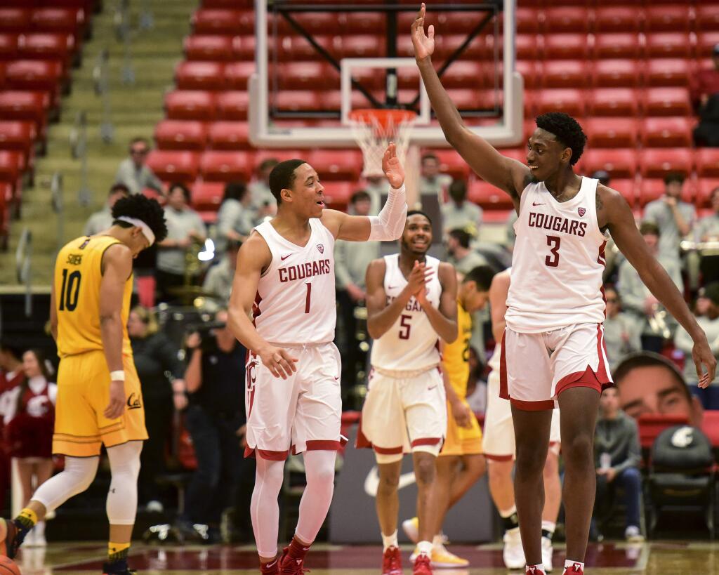 Washington State guard Jervae Robinson (1) and forward Robert Franks (3) celebrate after Cal coach Wyking Jones called a timeout during the second half, Thursday, Jan. 17, 2019, in Pullman, Wash. Washington State won 82-59. (Pete Caster/The Lewiston Tribune via AP)