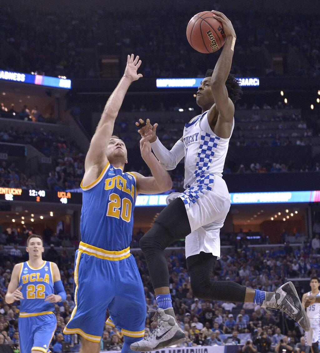 Kentucky guard De'Aaron Fox heads to the basket against UCLA guard Bryce Alford in the second half of an NCAA tournament South Region semifinal game Friday, March 24, 2017, in Memphis, Tenn. (AP Photo/Brandon Dill)