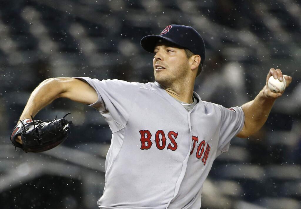 In this Oct. 1, 2015, file photo, Boston Red Sox starting pitcher Rich Hill delivers in the first inning of a game against the New York Yankees in New York. Hill has agreed to a $6 million, one-year contract with the Oakland Athletics. Hill took his physical in the Bay Area and the team announced the deal Friday, Nov. 20, 2015. (AP Photo/Kathy Willens, File)