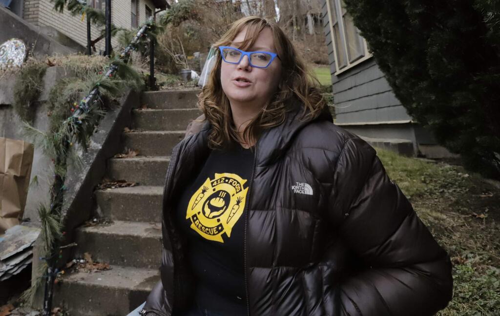 Rebecca Macleand, a housing program specialist for the U.S. Department of Housing and Urban Development in Pittsburgh, stands outside her home in Pittsburgh Thursday, Jan. 3, 2019. Maclean, 41, has been on furlough since Dec. 21. Her family's financial outlook isn't dire yet since her husband, Dan Thompson, owns a knife-making business and works as an elected constable. But the couple recently sat down to prioritize which bills must be paid on time and which can be paid late without dinging their credit history. (AP Photo/Gene J. Puskar)