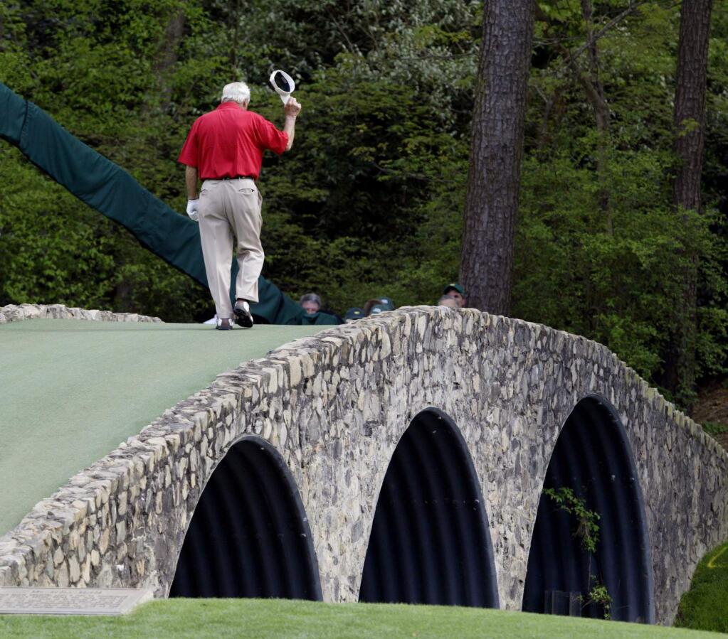 File- This April 9, 2004, file photo shows Arnold Palmer walking across the Hogan Bridge on the 12th fairway for the final time in Masters competition during the second round of the Masters golf tournament at the Augusta National Golf Club in Augusta, Ga. Palmer, who made golf popular for the masses with his hard-charging style, incomparable charisma and a personal touch that made him known throughout the golf world as 'The King,' died Sunday, Sept. 25, 2016, in Pittsburgh. He was 87. (AP Photo/Amy Sancetta, File)