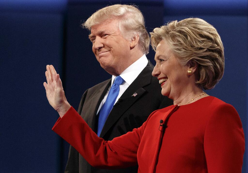Donald Trump stands with Hillary Clinton at Monday's presidential debate at Hofstra University in Hempstead, New York (EVAN VUCCI / Associated Press)