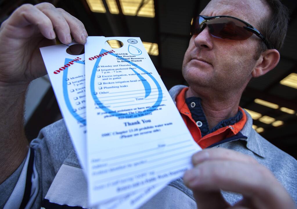 Robbi Pengelly/Index-TribuneCity of Sonoma Water Operations Supervisor Steve MacCarthy displays the notice left on front-door knobs if there is an obvious transgression of the city's current water restrictions. On Wednesday, city workers handed out 10 of them.