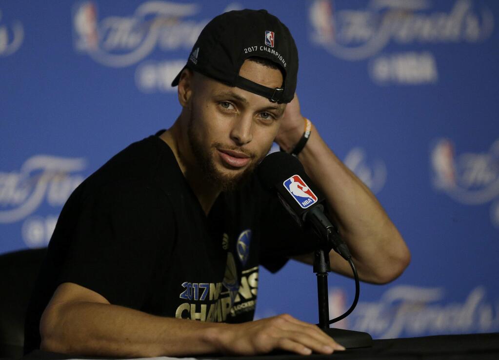 Golden State Warriors guard Stephen Curry speaks at a news conference after Game 5 of basketball's NBA Finals between the Warriors and the Cleveland Cavaliers in Oakland, Calif., Monday, June 12, 2017. The Warriors won 129-120 to win the NBA championship. (AP Photo/Ben Margot)
