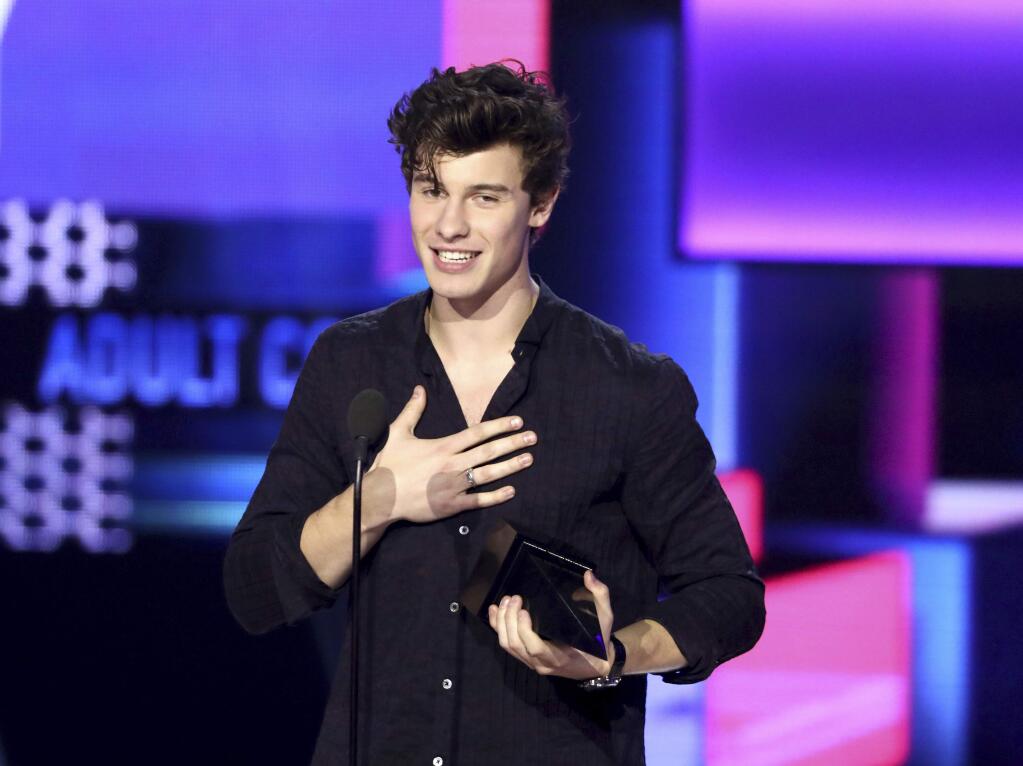 Shawn Mendes accepts the award for favorite artist adult contemporary at the American Music Awards at the Microsoft Theater on Sunday, Nov. 19, 2017, in Los Angeles. (Photo by Matt Sayles/Invision/AP)