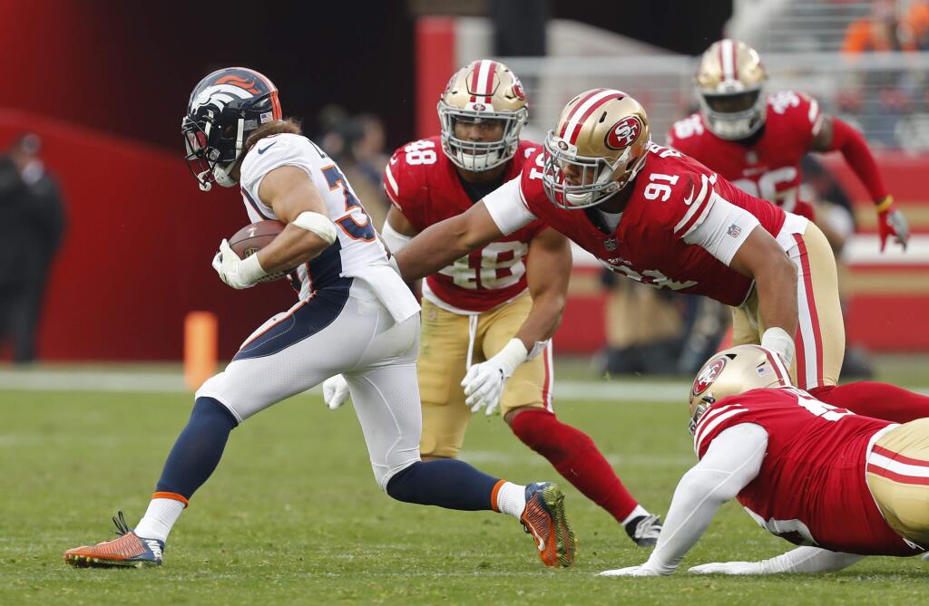 Denver Broncos running back Phillip Lindsay runs with the ball past San Francisco 49ers defensive end Arik Armstead (91) and middle linebacker Fred Warner (48) during the second half Sunday, Dec. 9, 2018, in Santa Clara. (AP Photo/Josie Lepe)