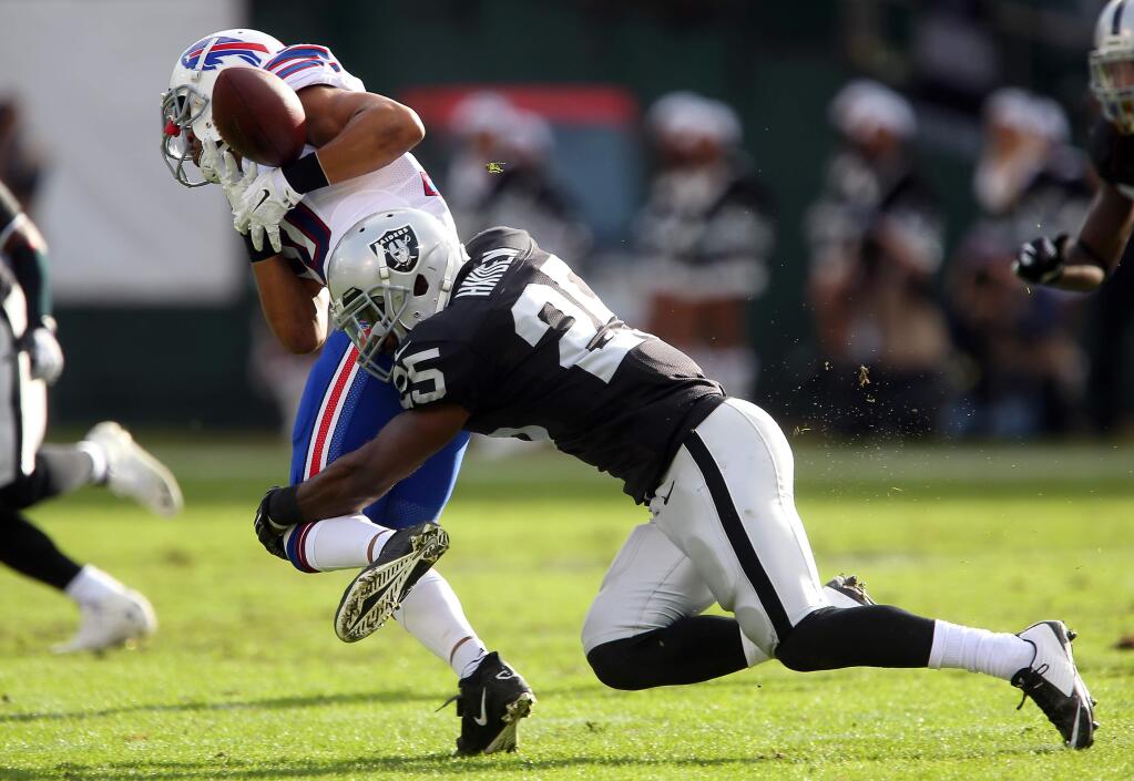 Oakland Raiders cornerback D.J. Hayden breaks up a pass intended for Buffalo Bills wide receiver Robert Woods during their game in Oakland on Sunday, Dec. 21, 2014. The Raiders defeated the Bills 26-24. (Christopher Chung / The Press Democrat)