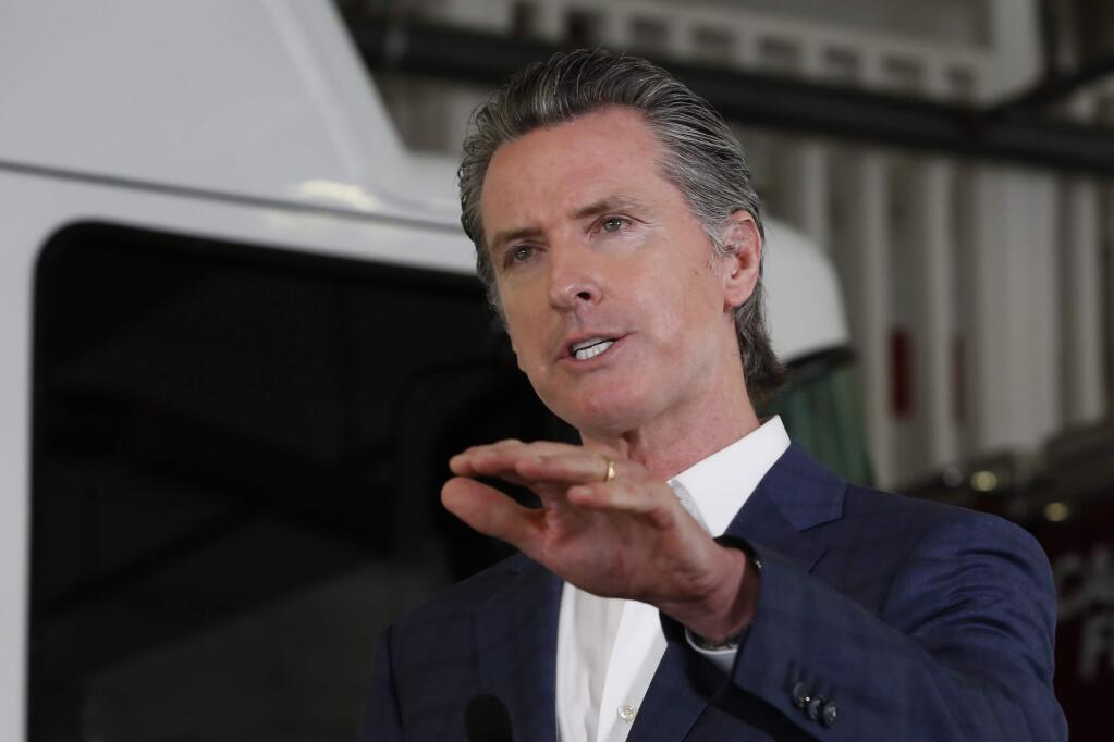 Gov. Gavin Newsom discusses California's response to the coronavirus during a news conference at the CalFire/Cameron Park Fire Station in Cameron Park, Calif., Wednesday, May 13, 2020. Newsom warned against Californians traveling unnecessarily across counties as some begin to reopen their economies at a faster pace than others. (AP Photo/Rich Pedroncelli, Pool)