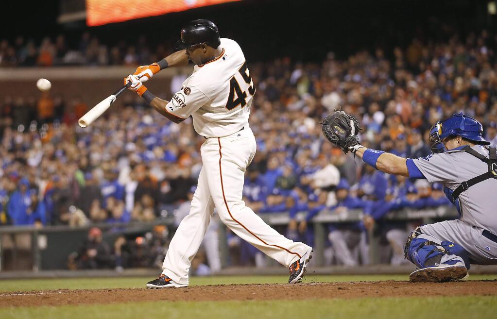 San Francisco Giants' Alejandro De Aza (45) hits a sacrifice fly ball to drive a run against the Los Angeles Dodgers in the twelved inning of a baseball game Monday, Sept. 28, 2015, in San Francisco. Giants won in extra innings 3-2. (AP Photo/Tony Avelar)