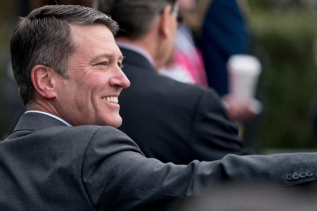 FILE - In this April 2, 2018, file photo, White House physician and nominee for Veterans Affairs Secretary Dr. Ronny Jackson arrives at the annual White House Easter Egg Roll on the South Lawn of the White House in Washington. Now it's Washington's turn to examine Jackson. The doctor to Presidents George W. Bush, Barack Obama and now Donald Trump is an Iraq War veteran nominated to head the Department of Veterans Affairs. (AP Photo/Andrew Harnik, File)