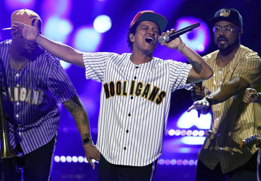 FILE - In this Sunday, June 25, 2017, file photo, Bruno Mars performs 'Perm' at the BET Awards at the Microsoft Theater in Los Angeles. Mars is the top nominee with eight nods at the American Music Awards, while The Chainsmokers, Drake, Kendrick Lamar, Ed Sheeran and The Weeknd all earned five nominations each. The show will broadcast live from the Microsoft Theater in Los Angeles on Nov. 19 at 8:00 p.m. Eastern on ABC. (Photo by Matt Sayles/Invision/AP, File)