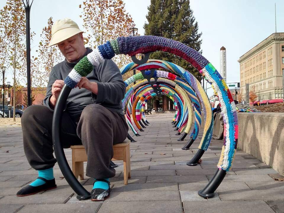 Public art champion Judy Kennedy fits bike racks on Old Courthouse Square with yarnbombs, Wednesday, Nov. 22, 2017. (Photo: Camille Armstrong)